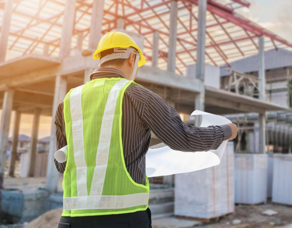 Worker with safety harness on rooftop